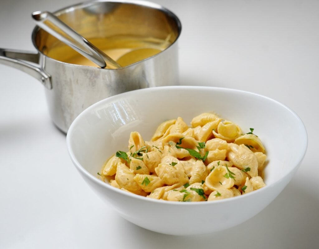 bowl and sauce pan of the cottage cheese mac and cheese