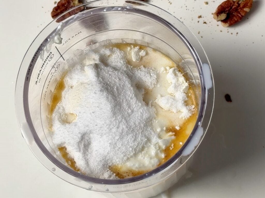 butter pecan creami about to spin with ingredients