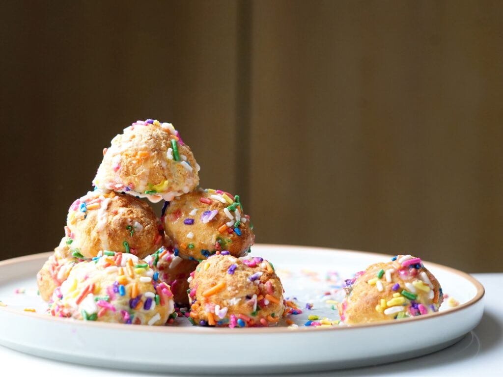 close up birthday cake donut holes on plate