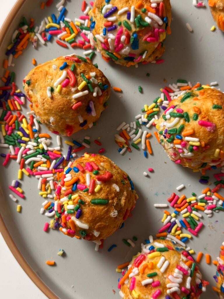 close up birthday cake donut holes on plate overhead