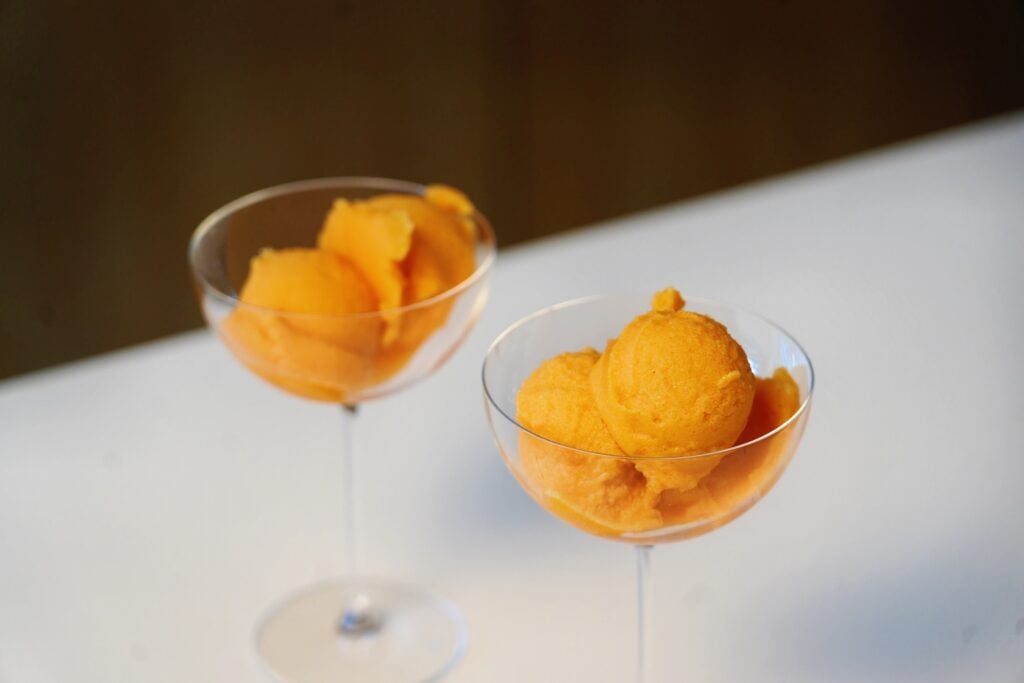close up carrot and orange sorbet overhead