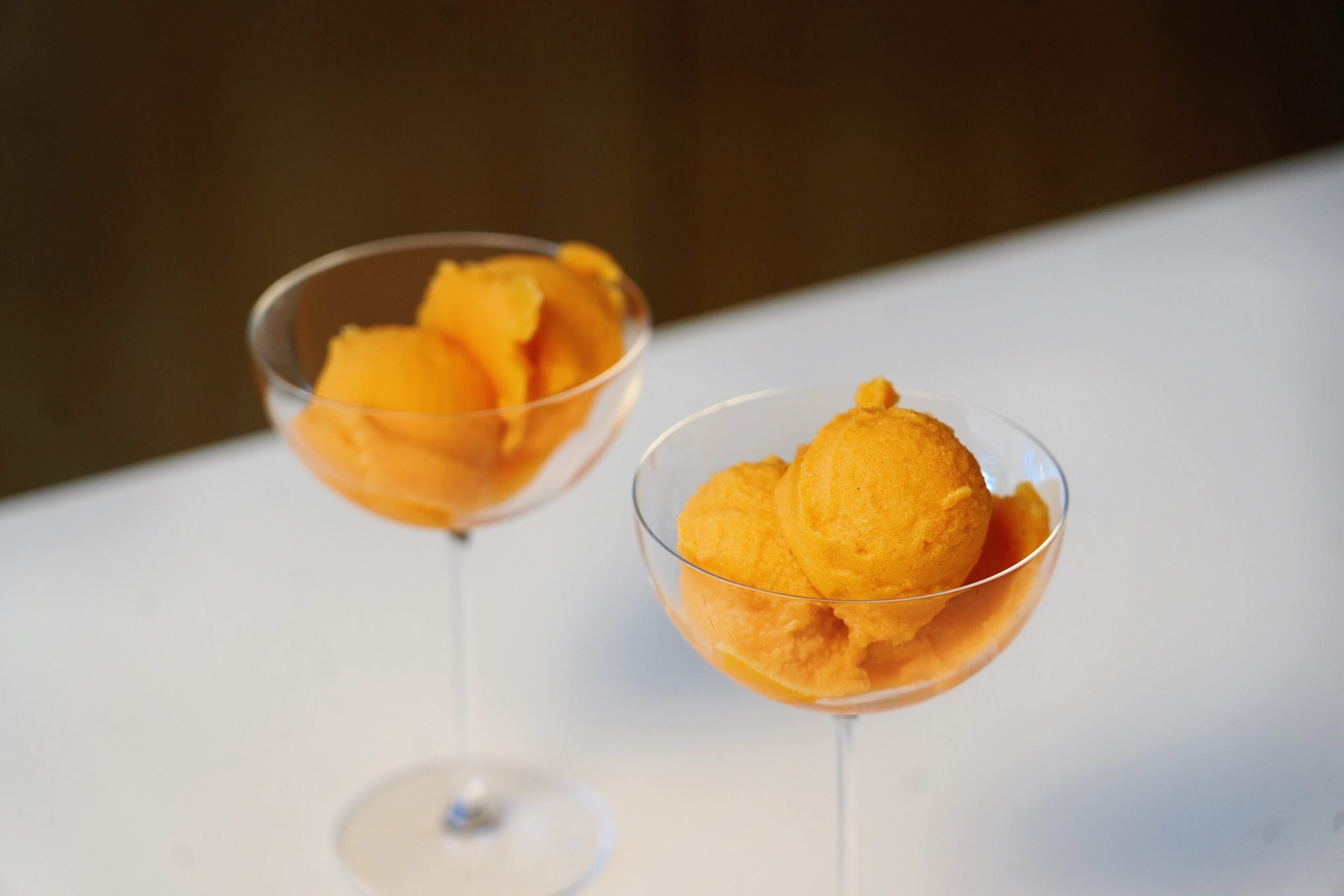 close up carrot and orange sorbet overhead