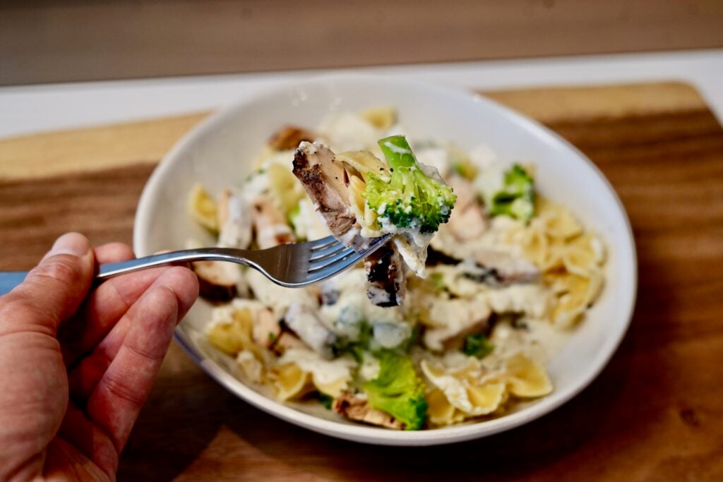 finished broccoli and chicken pasta plated with fork