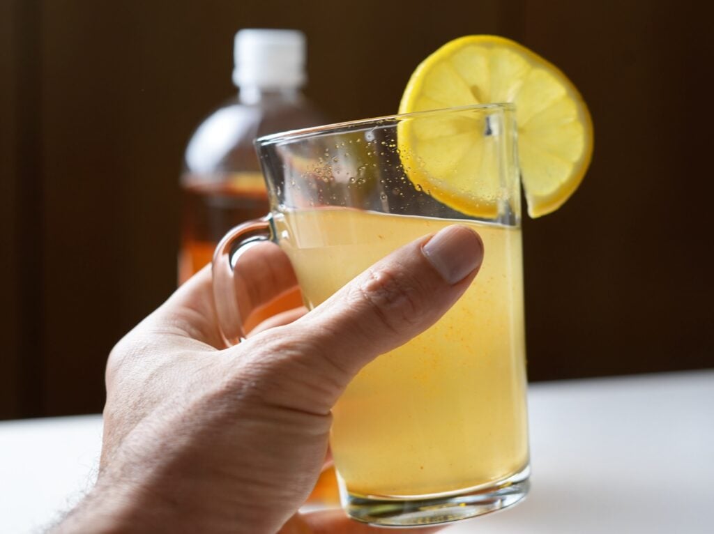 hand holding apple cider vinegar weight loss drink