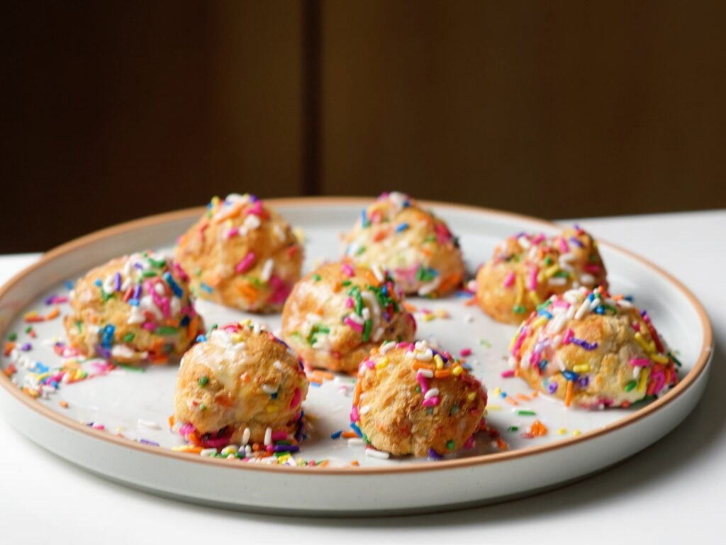 iced funfetti birthday cake donut holes on plate