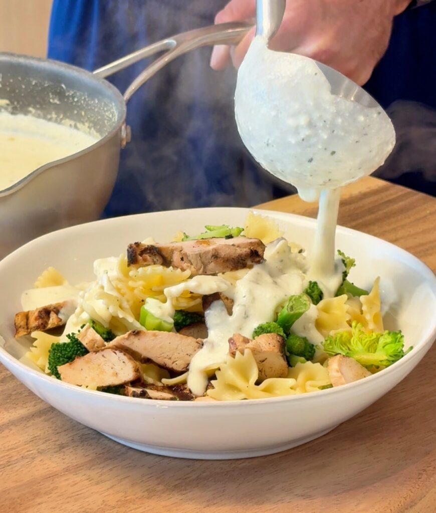 pouring sauce on pasta