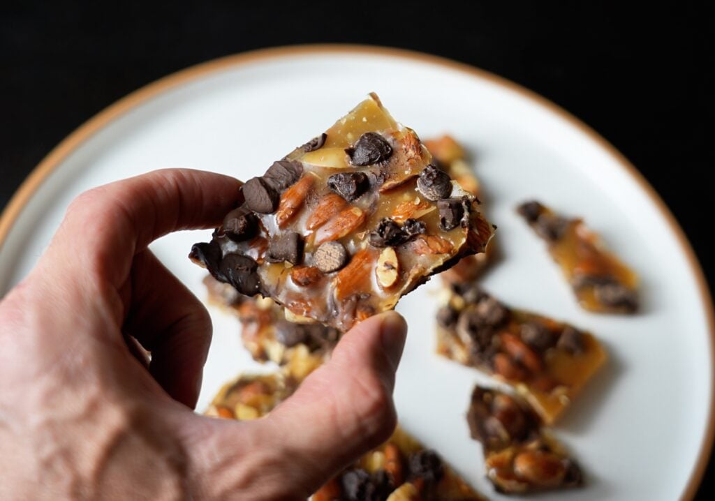 vintage almond chocolate chip brittle in hand