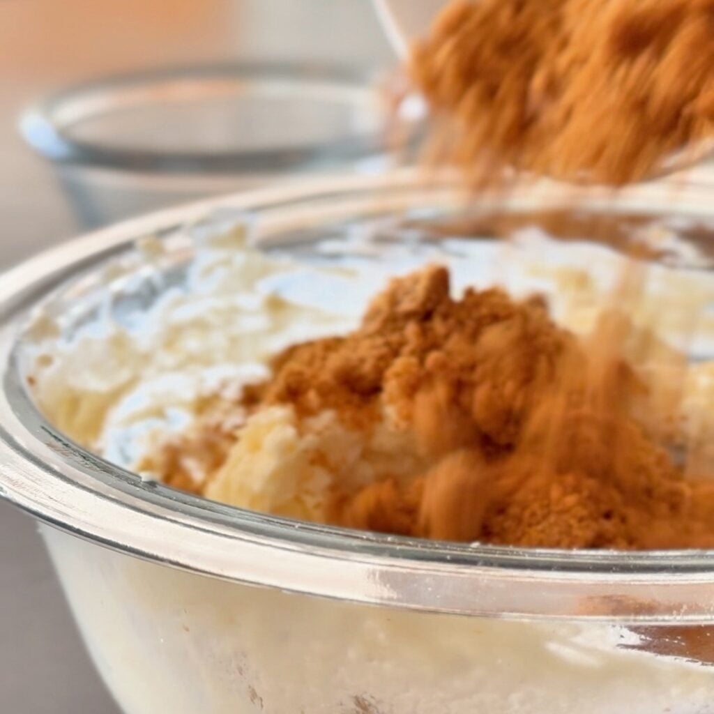 adding cookies to biscoff fluffy yogurt