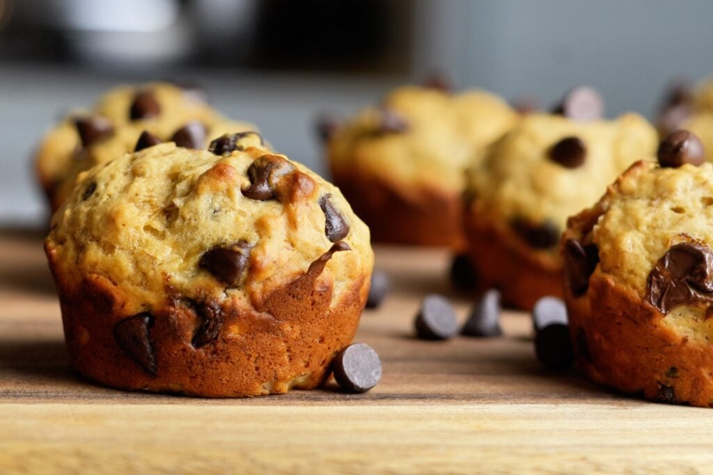 high protein banana bread muffin on board wide shot