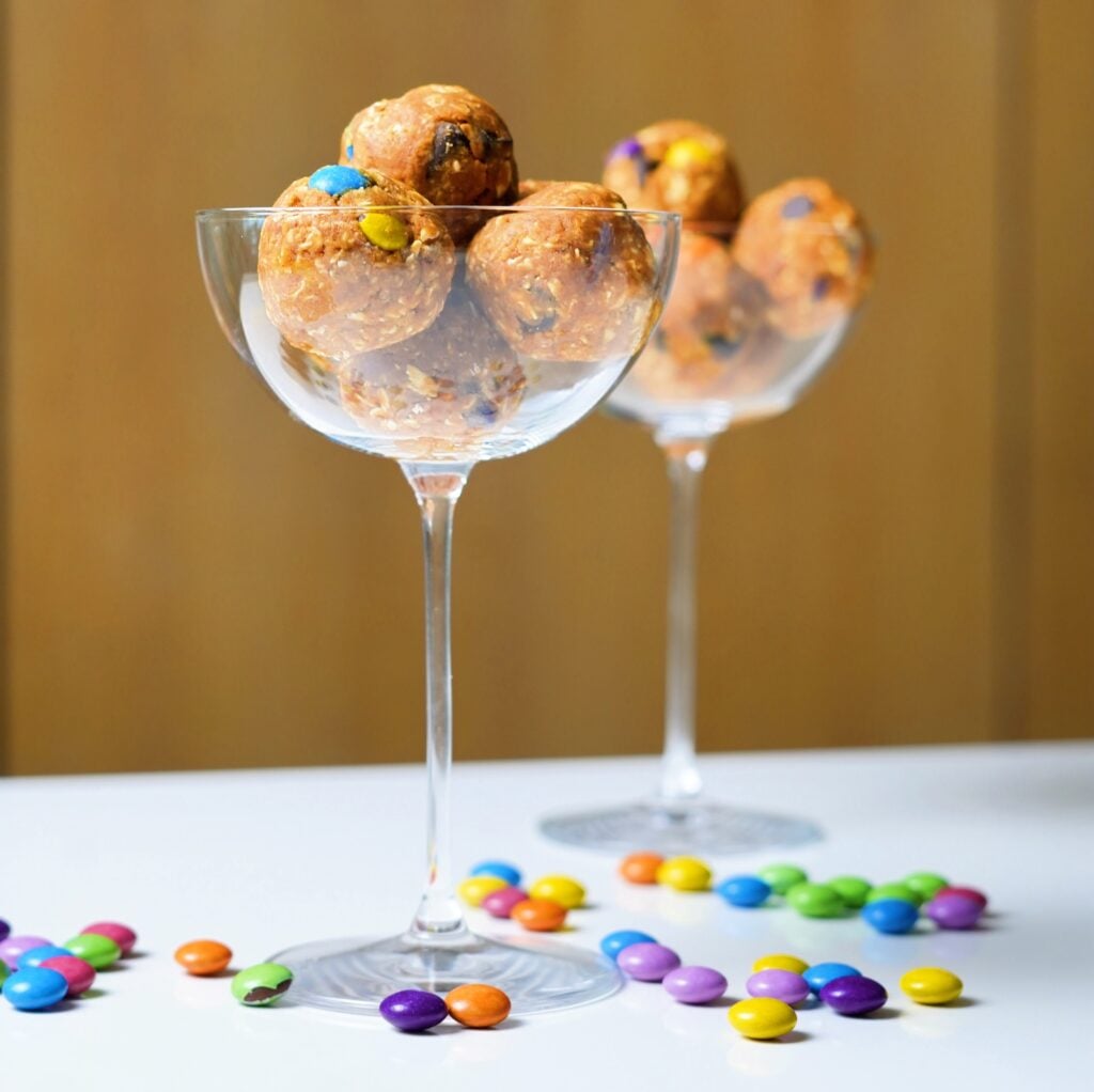 high protein monster cookie balls in glasses tall