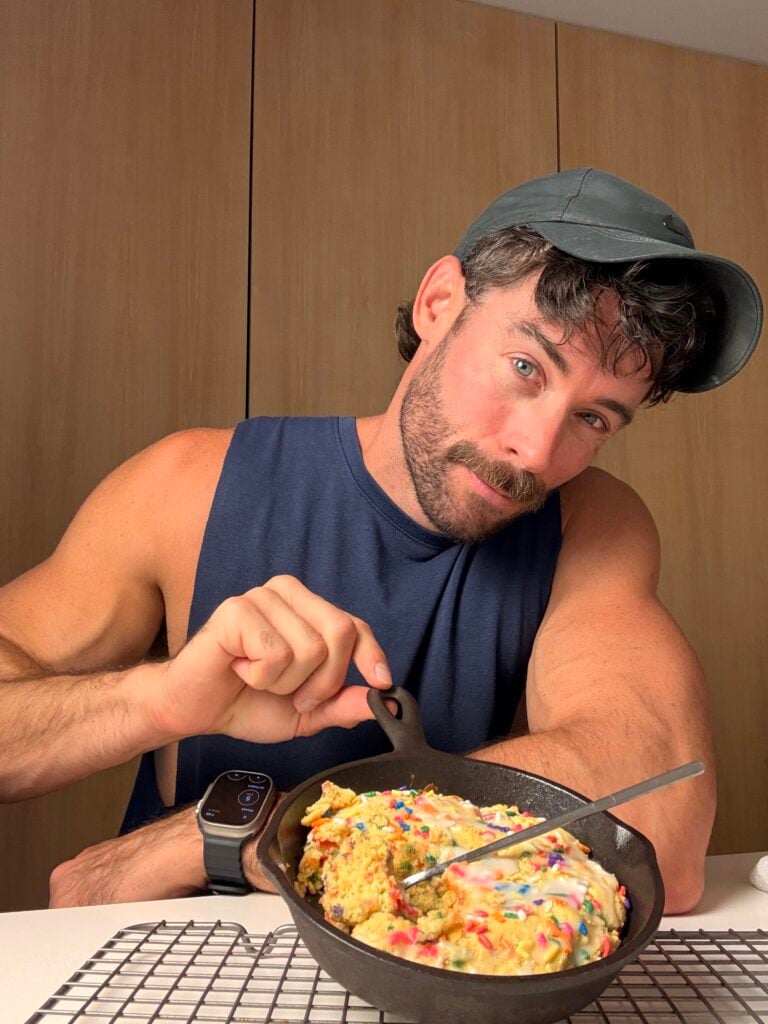 jacob eating the birthday cake protein cookie skillet with a spoon on counter