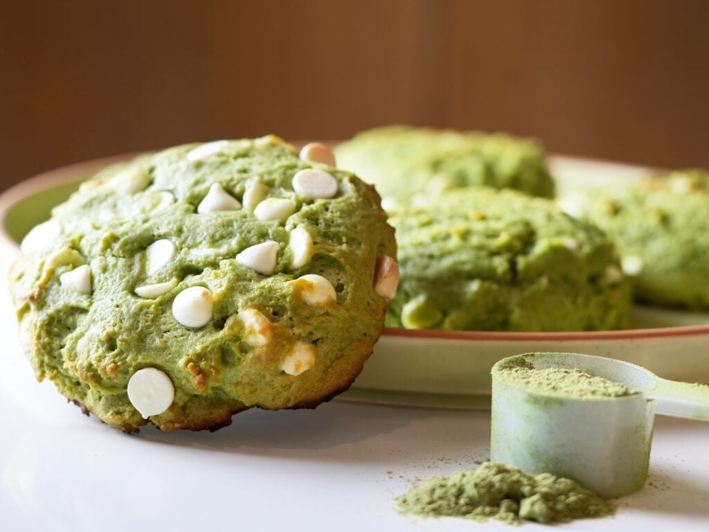 matcha and greens protein cookie on board with others