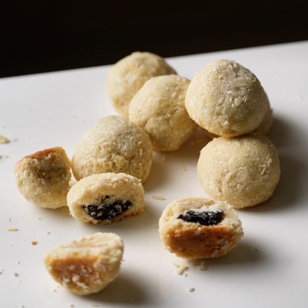 pile of row of coconut surprise cookies with nuts and fruit