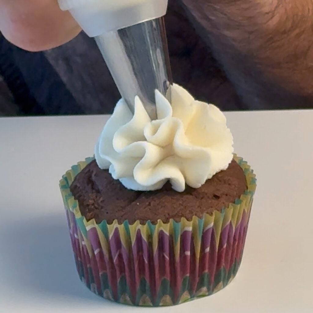 piping the high protein keto cream cheese frosting