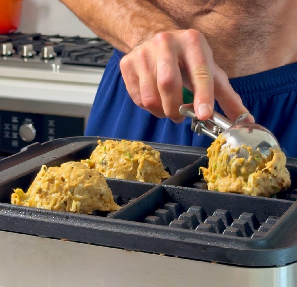 scooping waffles into iron