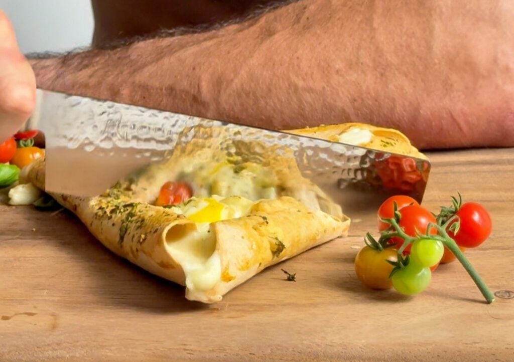 slicing stuffed crust italian omelet