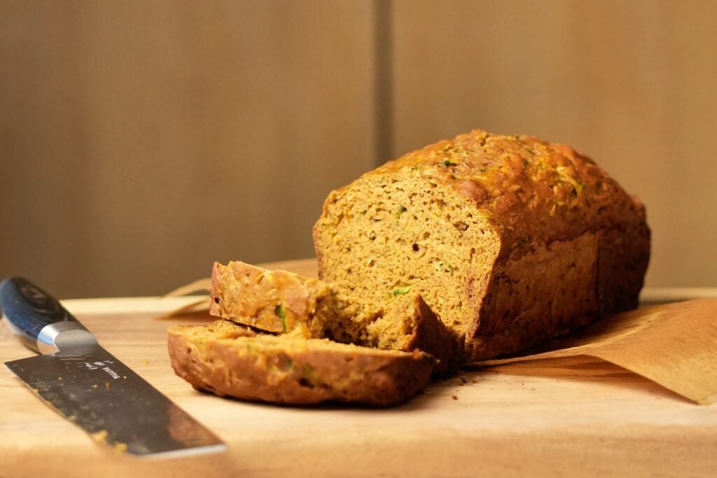 wide hero shot of zucchini bread with knife