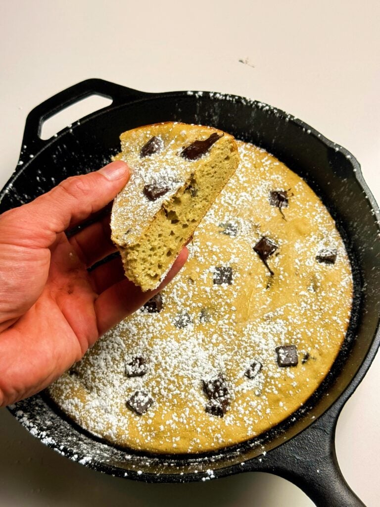 holding a slice of the banana bread
