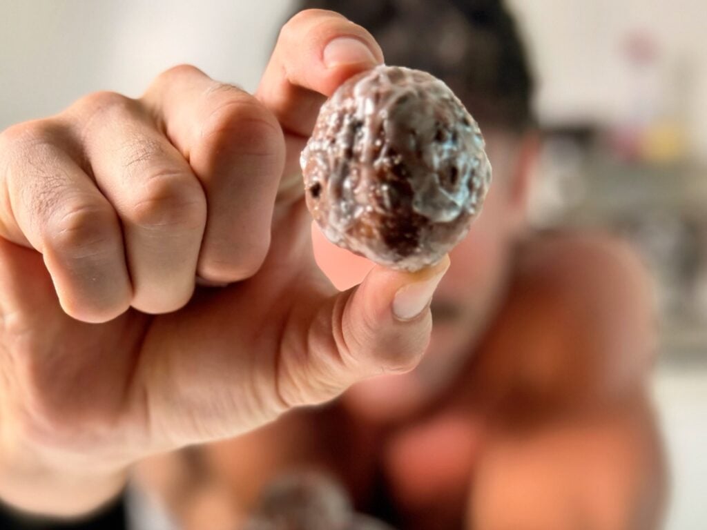jacob holding a chocolate donut hole
