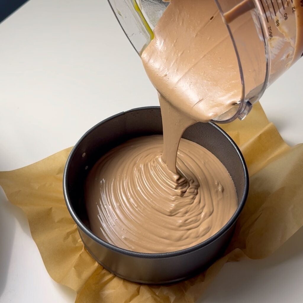 pouring cheesecake batter