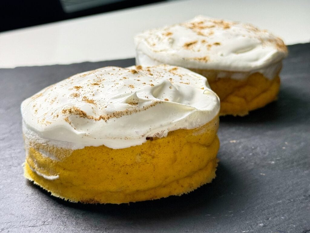 Close-up of high protein pumpkin pie cheesecake with whipped cream topping