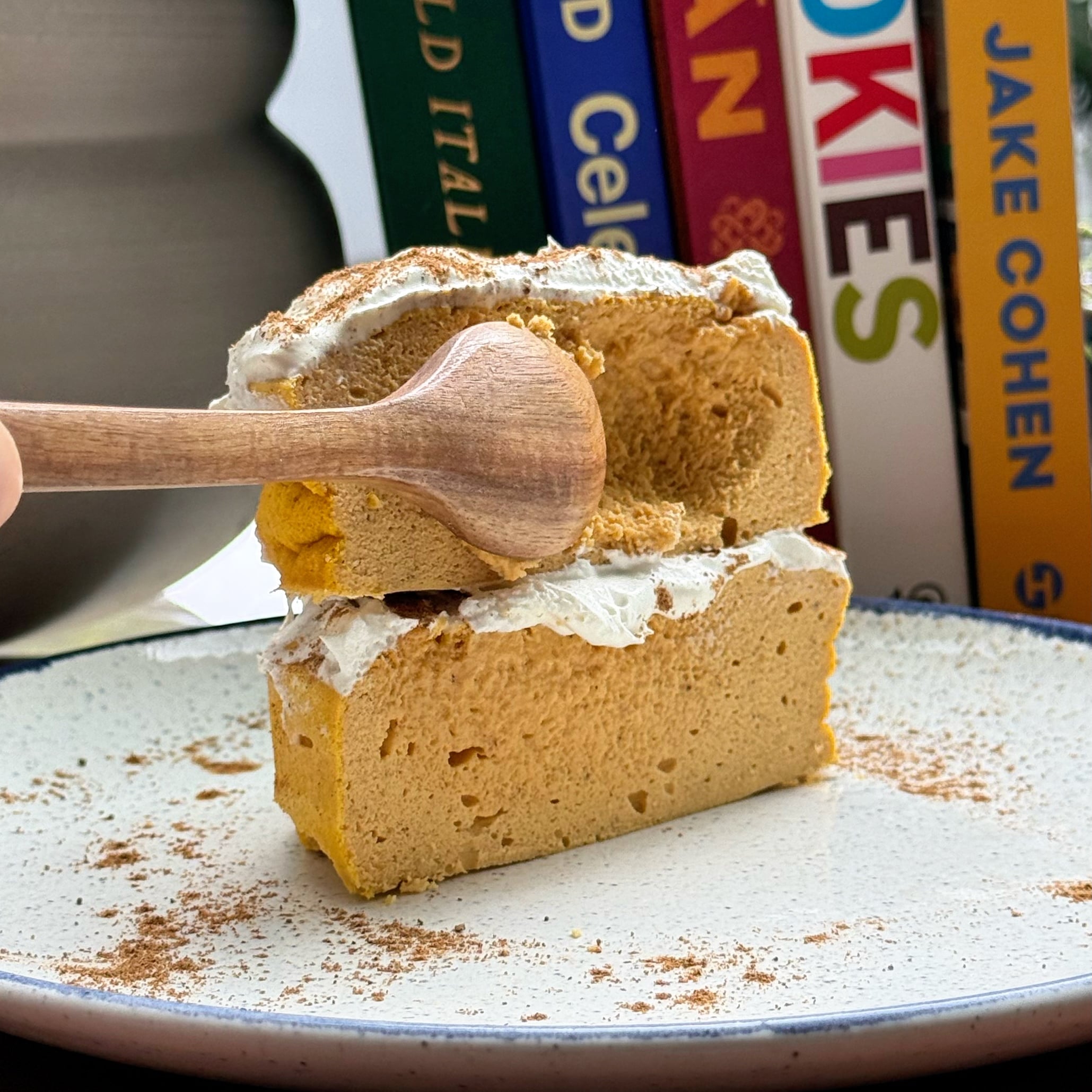 Slices of high protein pumpkin pie cheesecake on a cutting board