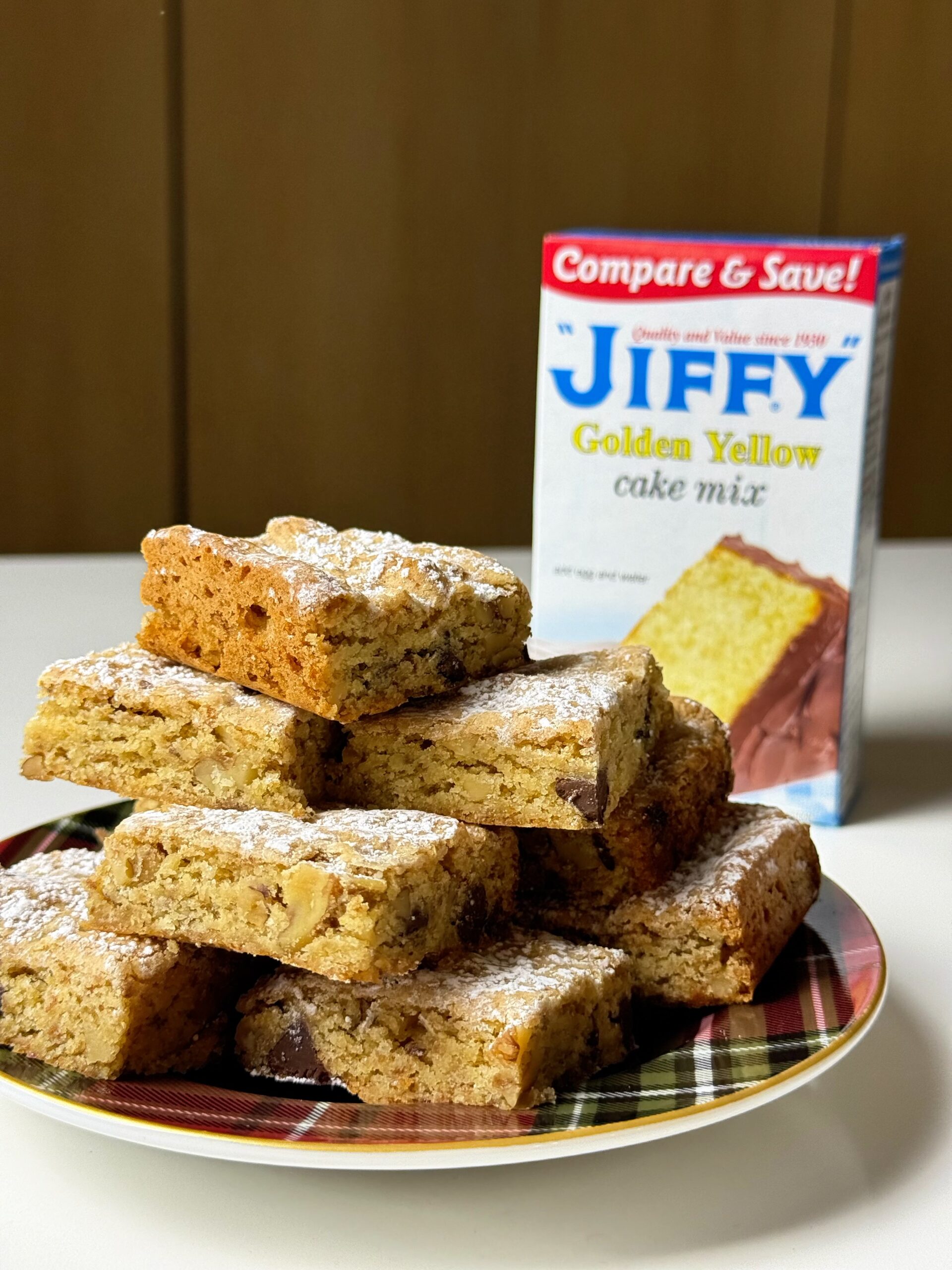 Stack of vintage chewy bars beside a box of Jiffy Golden Yellow Cake Mix.