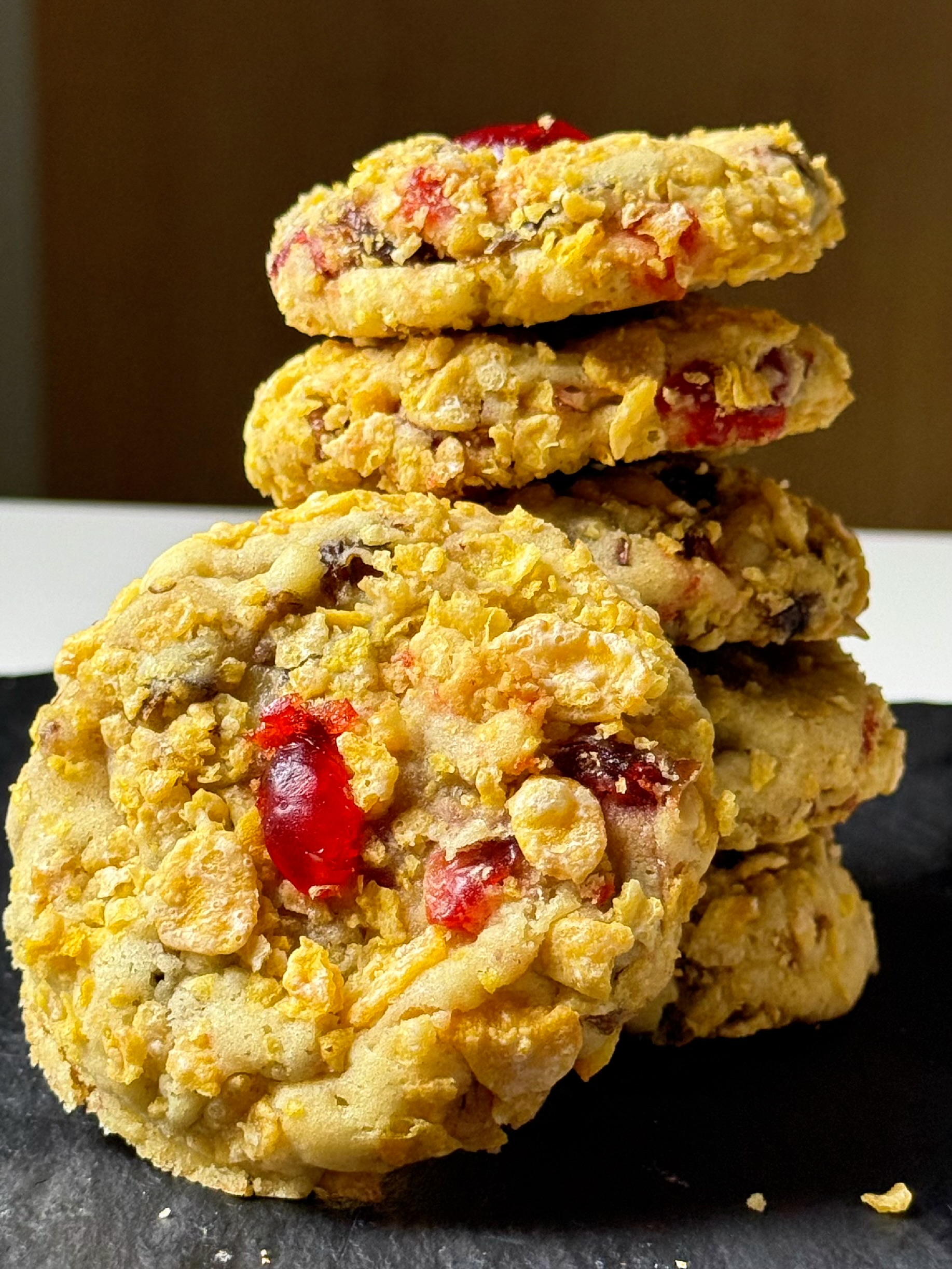 Stack of vintage Cherry Winks cookies showing dates, pecans, candied cherries, and corn flake coating.
