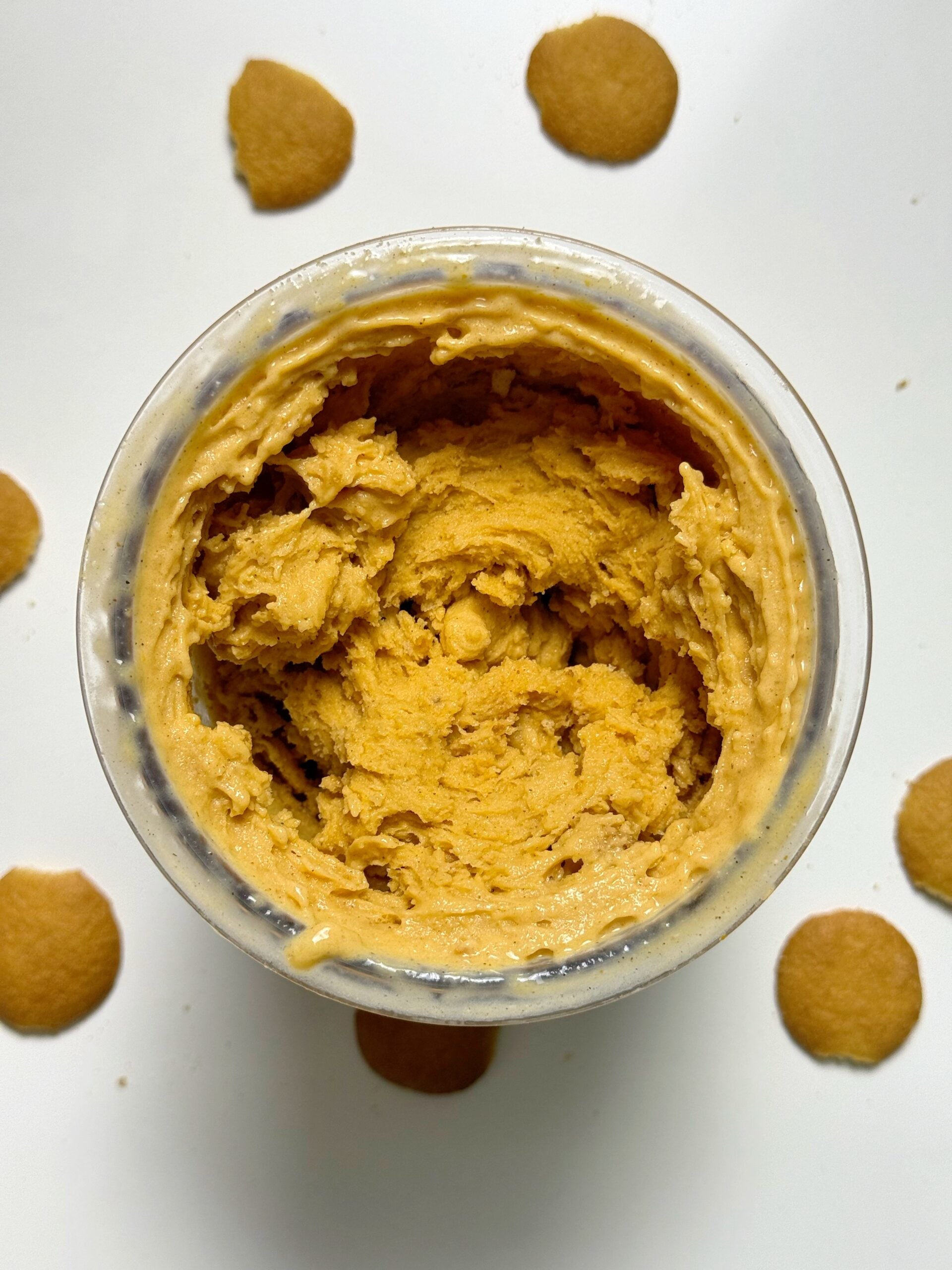 Overhead view of pumpkin pie Ninja Creami in the pint container surrounded by cookies