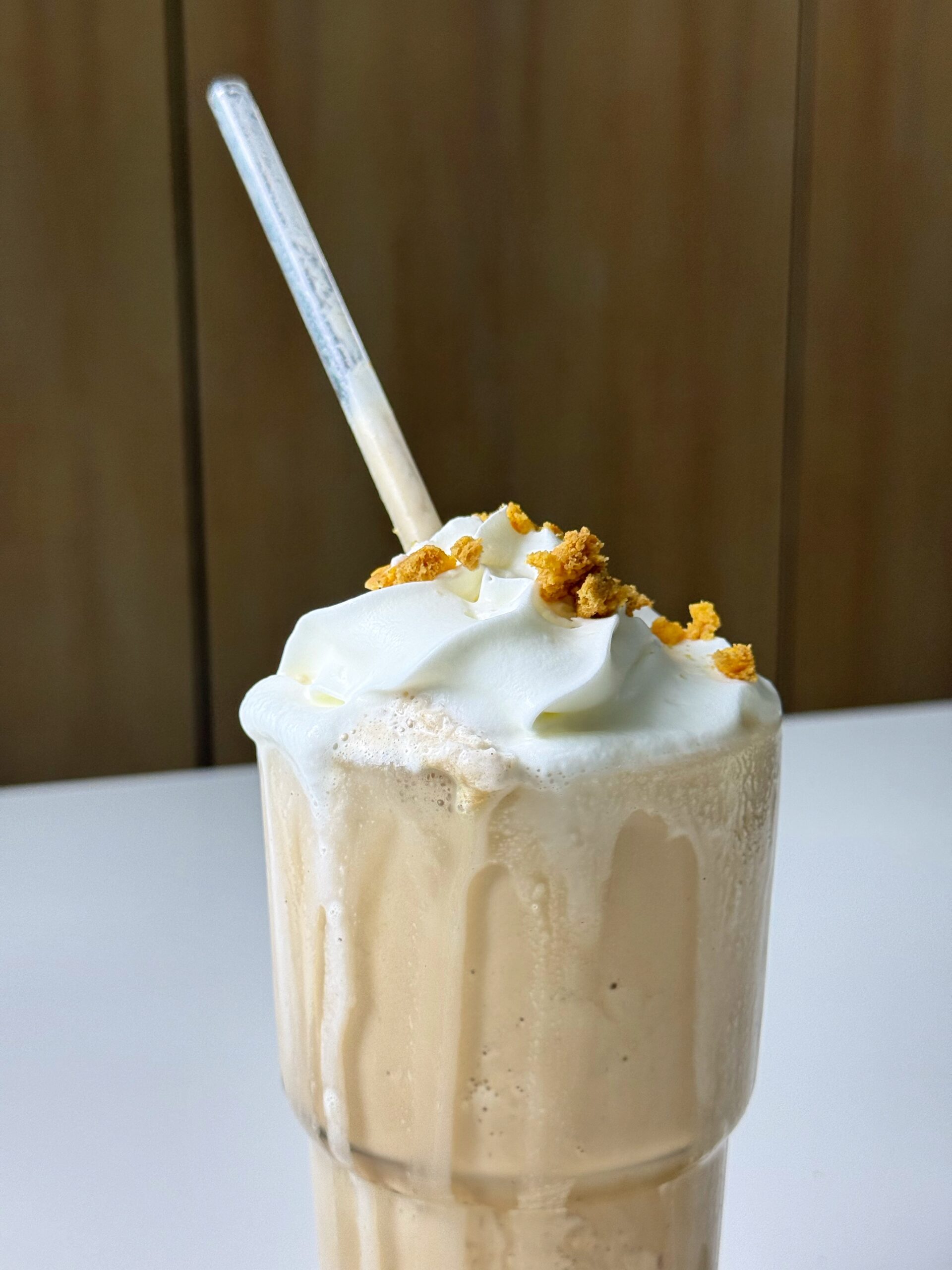 Pumpkin spice protein frappé topped with whipped cream and crumbled cookies