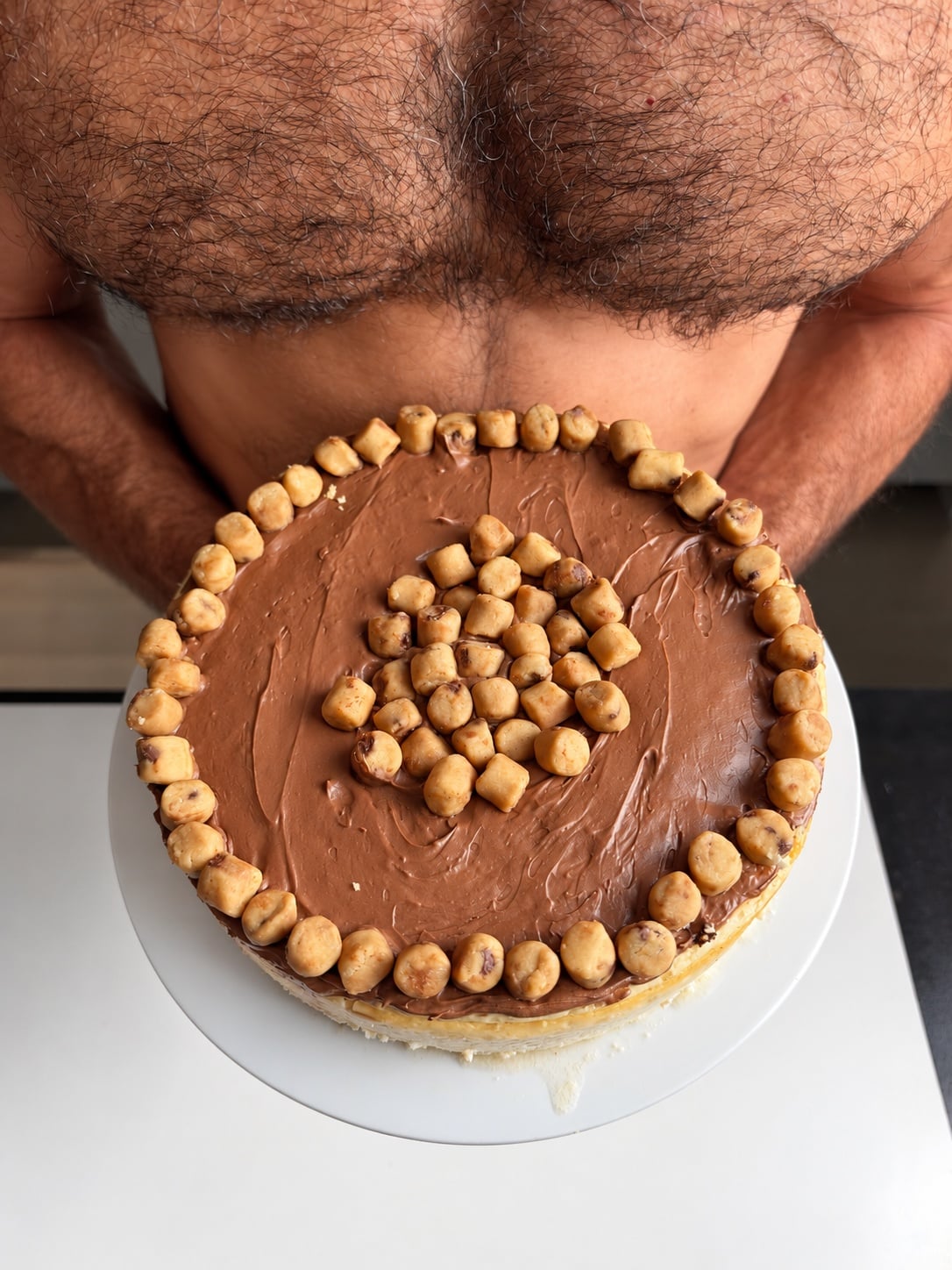 Jacob holding high-protein cookie dough cheesecake overhead
