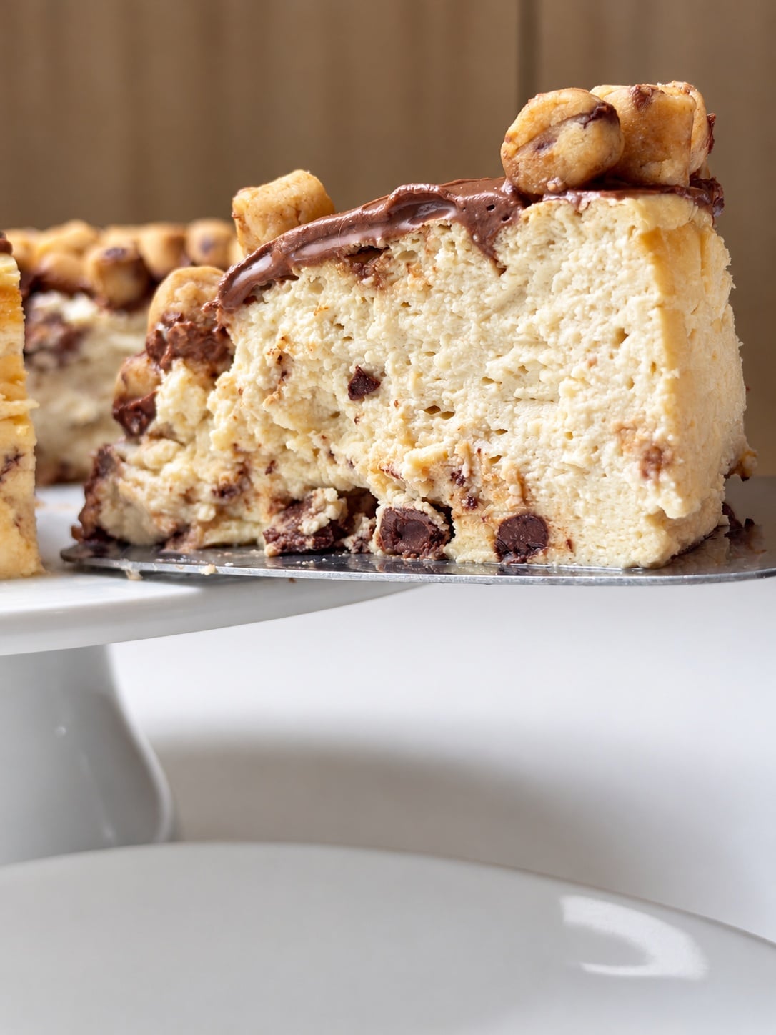 Close-up of cookie dough cheesecake slice showing creamy texture and chocolate chips