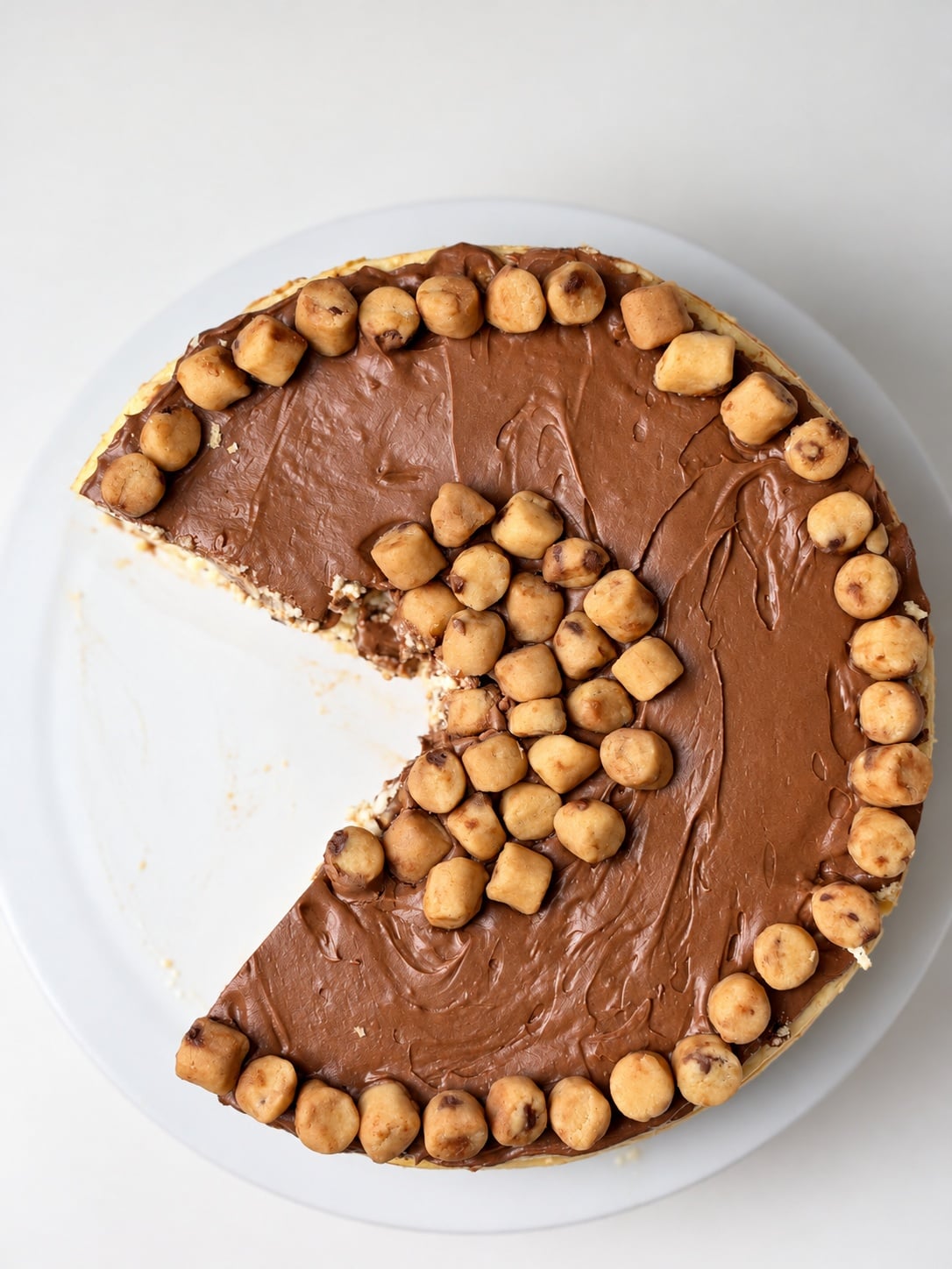 Overhead view of cut cookie dough cheesecake with one slice removed