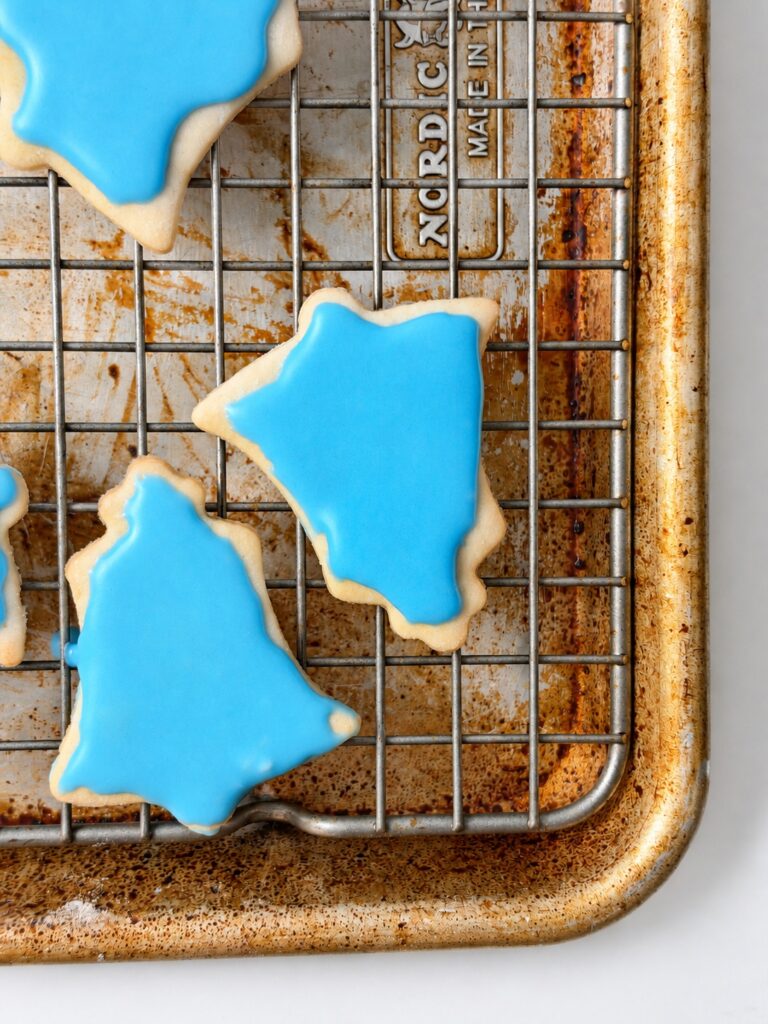 Blue iced cream cheese sugar cookies shaped like bells