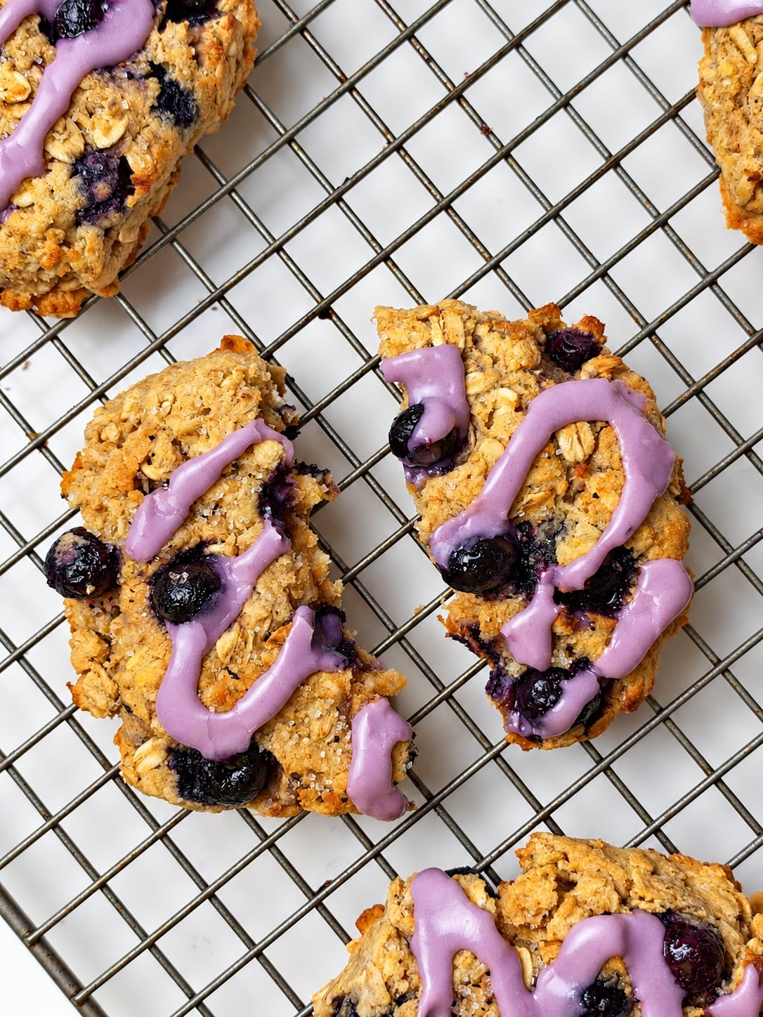 Broken glazed blueberry breakfast cookies showing the soft oatmeal center