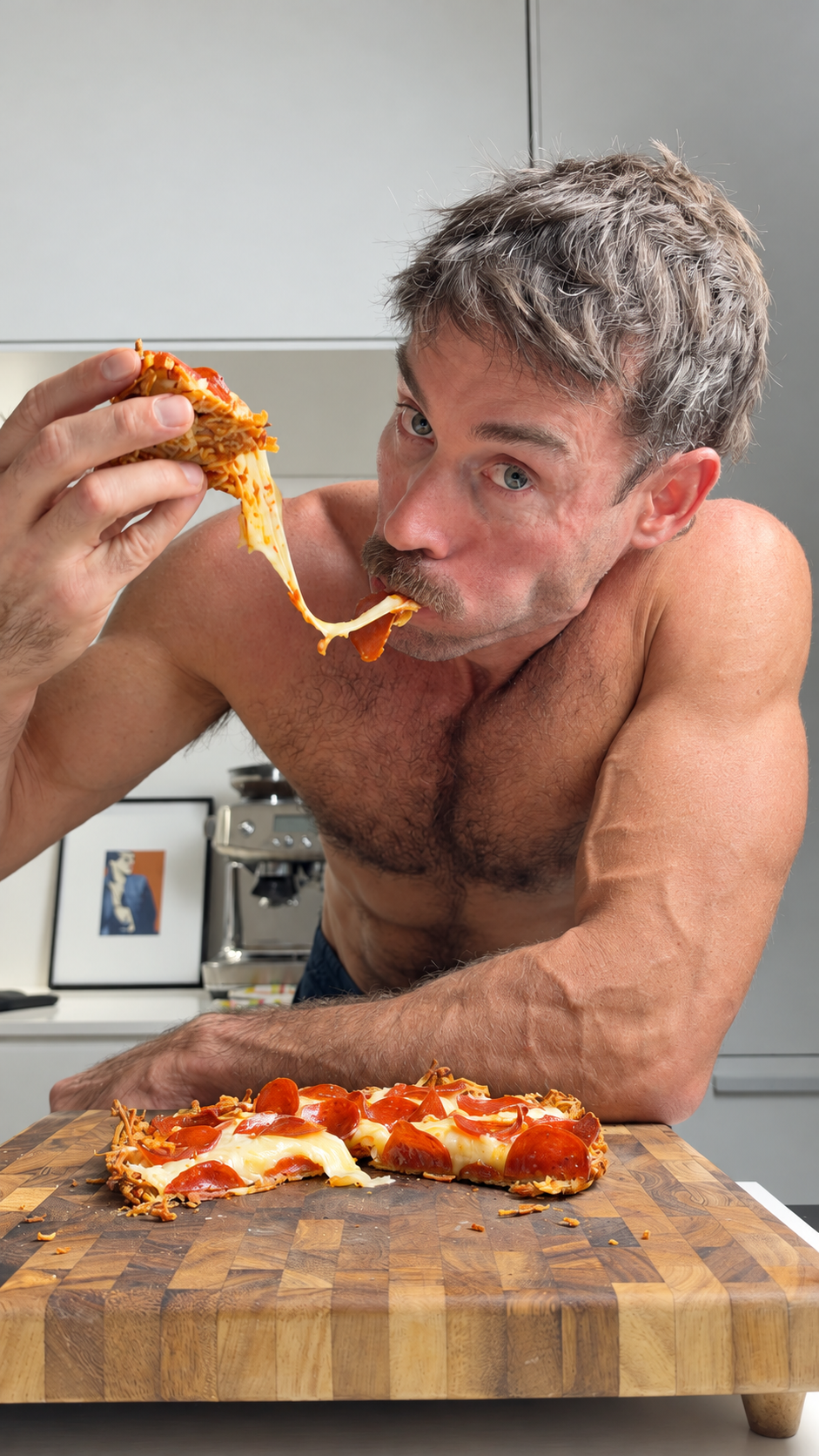 Jacob eating a slice of high-protein hash brown pizza with a cheese pull in the kitchen