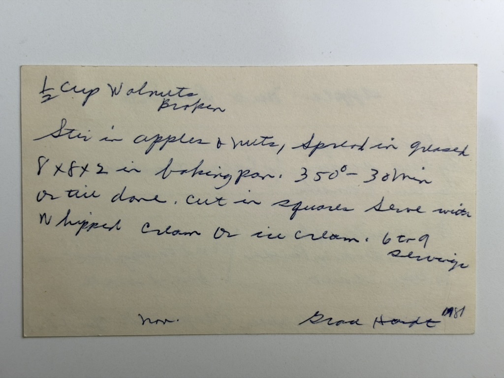 Back of Great-Grandma’s handwritten Apple Nut Dessert recipe card with walnuts, baking temperature, pan size, serving directions, and yield.