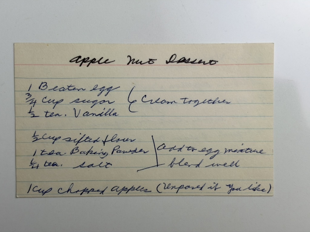 Front of Great-Grandma’s handwritten Apple Nut Dessert recipe card with the egg, sugar, vanilla, flour, baking powder, salt, and chopped apple ingredients.