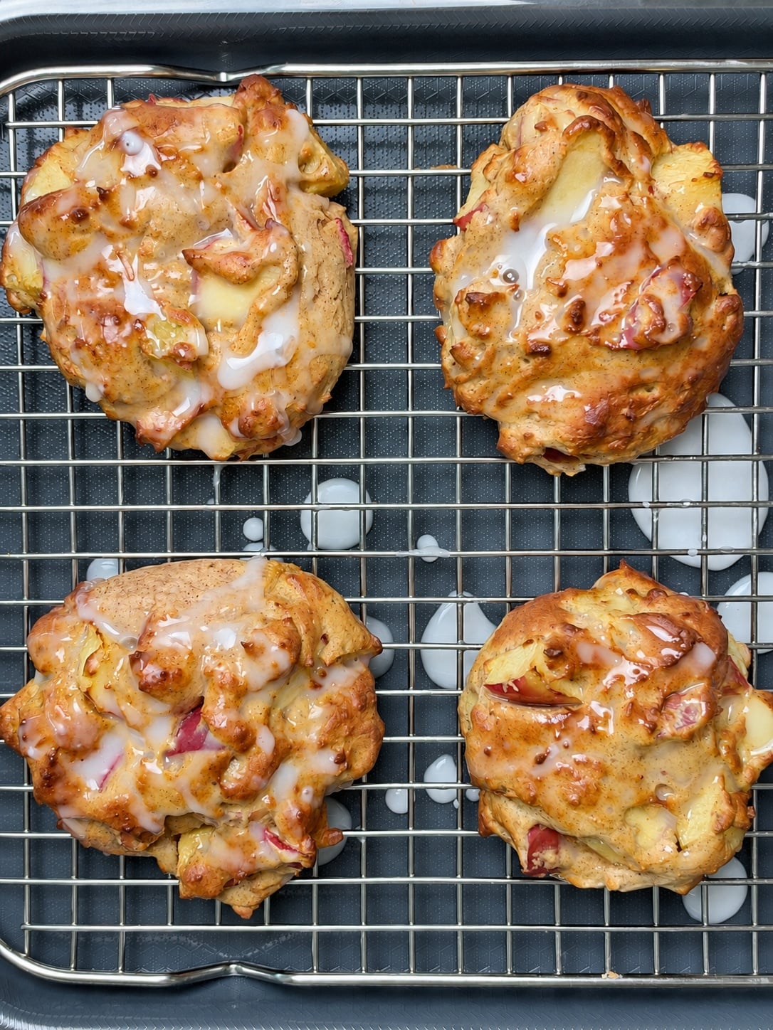 Glazed high-protein apple fritters cooling on a wire rack