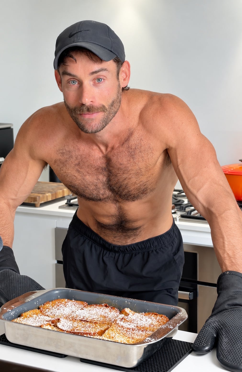 Jacob standing in the kitchen behind a freshly baked pan of high-protein French toast casserole.