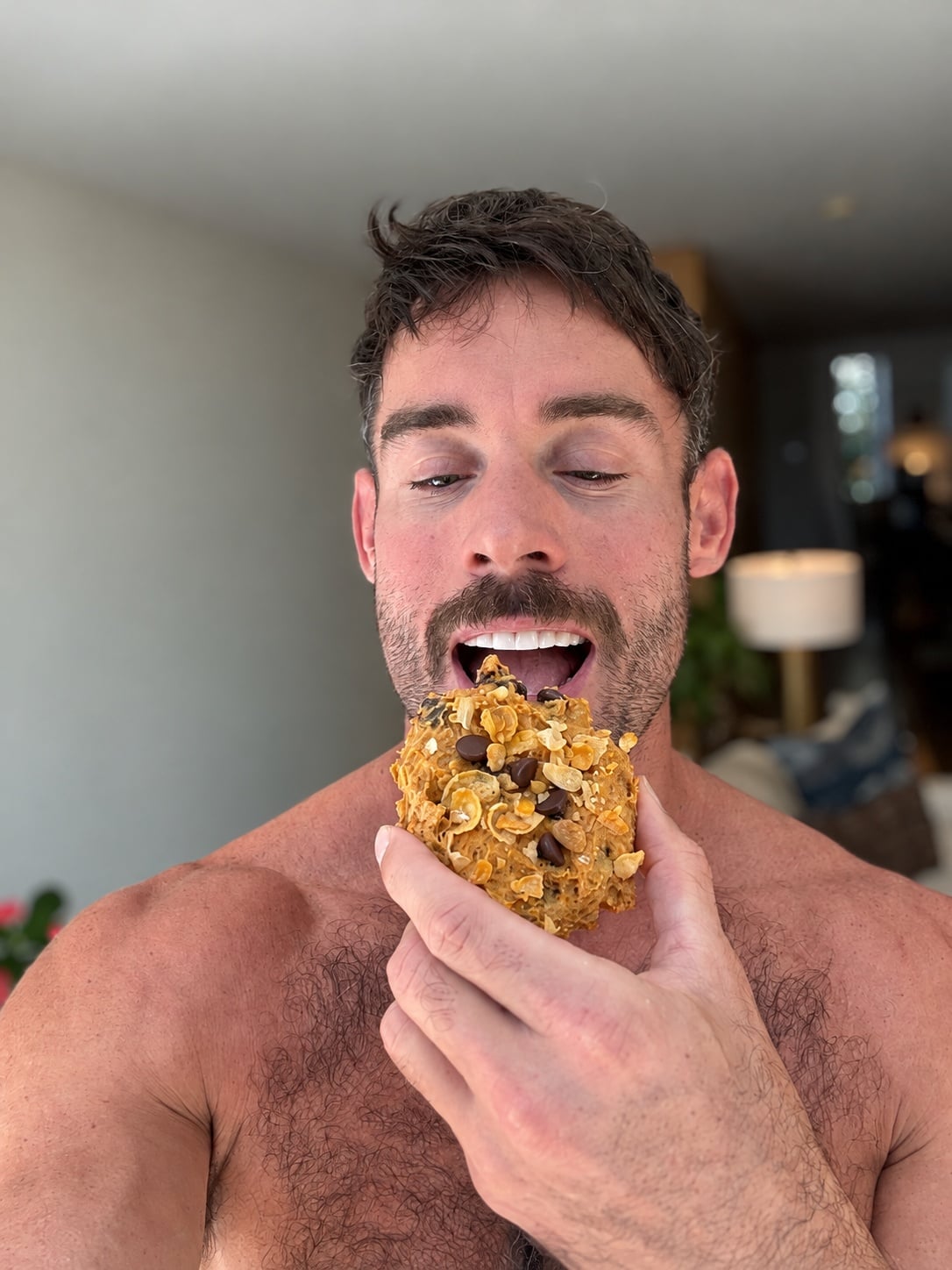 Jacob Hensley holding a pumpkin corn flake protein breakfast cookie