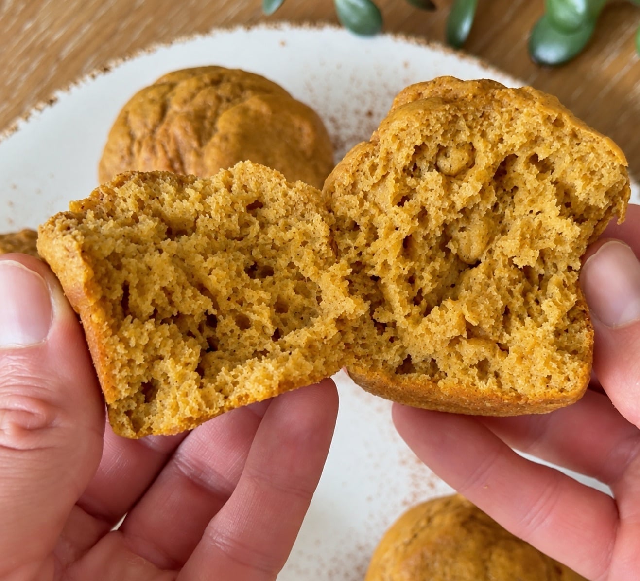Split pumpkin protein muffin showing its soft spiced interior crumb
