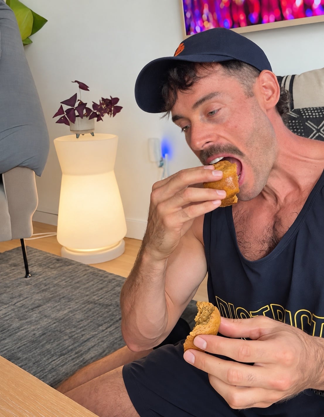 Jacob tasting a pumpkin protein muffin and holding the split muffin interior