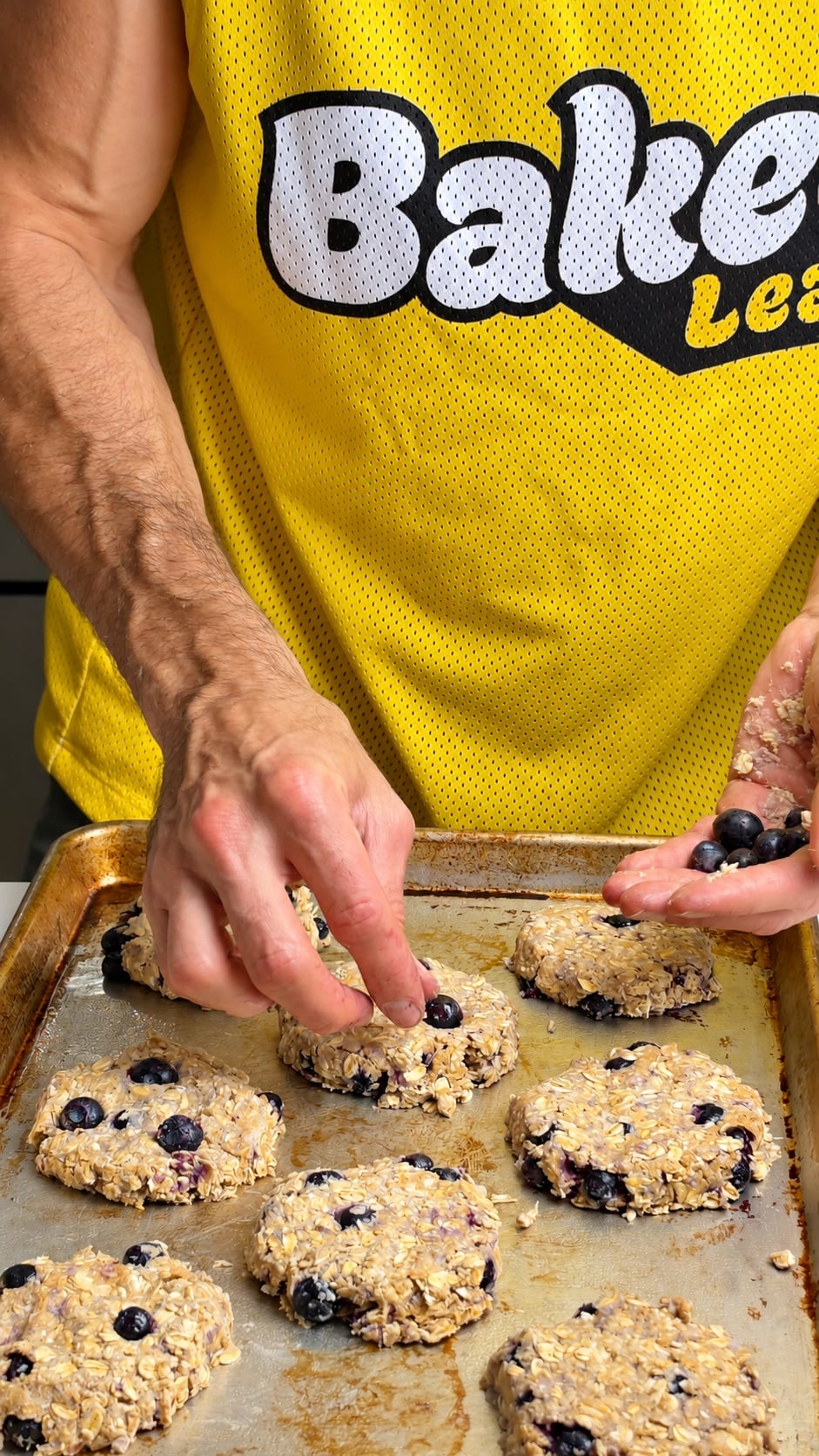 Shaping blueberry oatmeal breakfast cookies on a baking sheet before baking