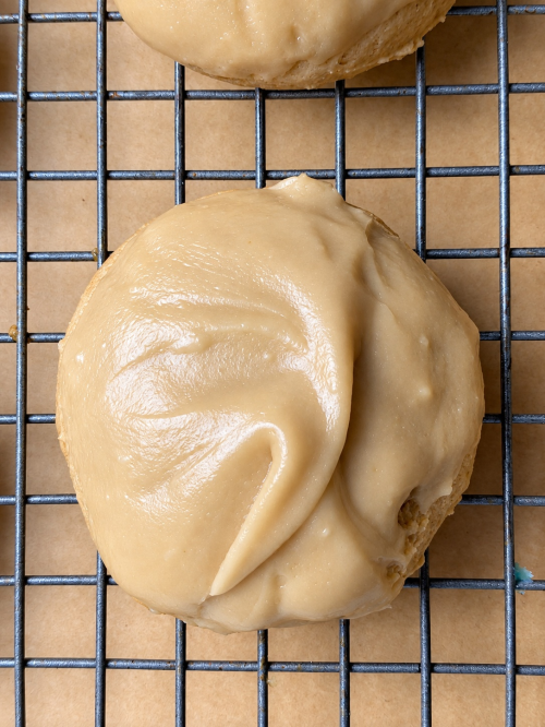 Close-up of a soft brown sugar cookie covered with glossy brown sugar frosting
