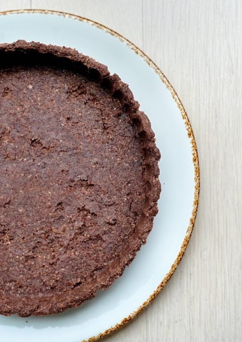 Close-up of baked low-carb chocolate almond flour tart crust texture.
