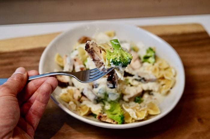 finished broccoli and chicken pasta plated with fork