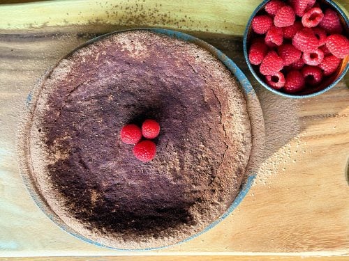 Overhead view of flourless torta caprese with raspberries