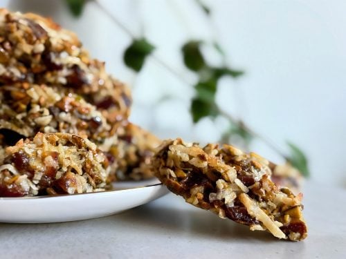 Homemade Hedge Hog cookies made with coconut, dates, and walnuts on a plate.